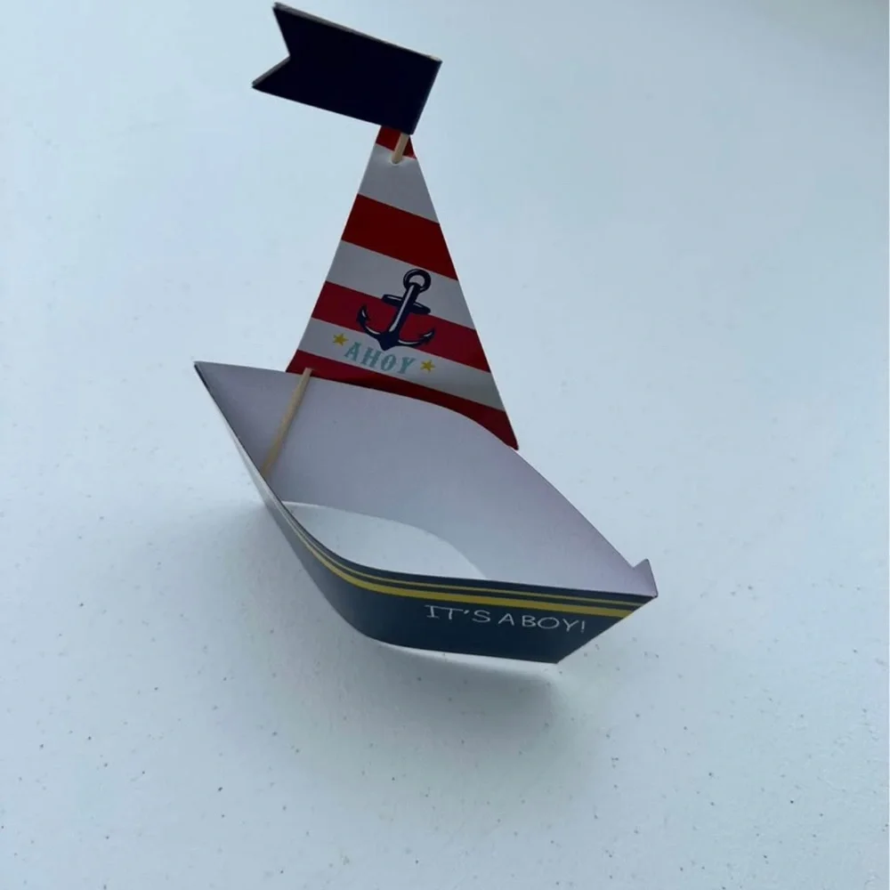 20 It’s A Boy sailboat cupcake holders and toppers